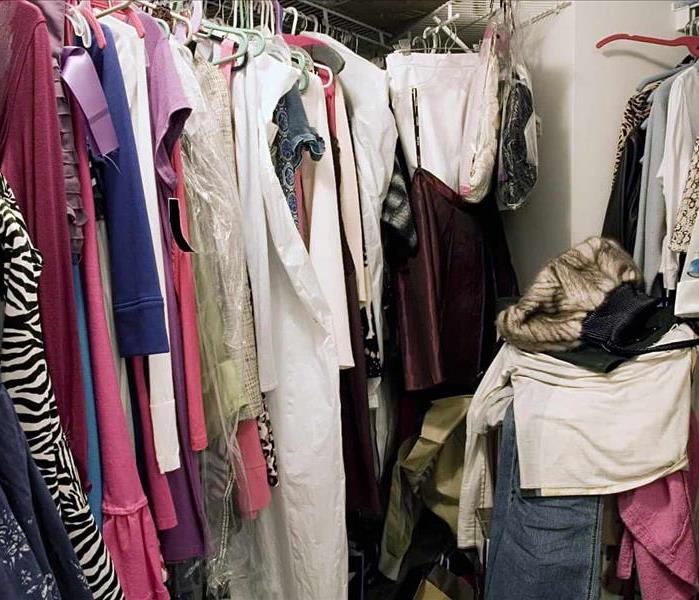Messy closet of clothes